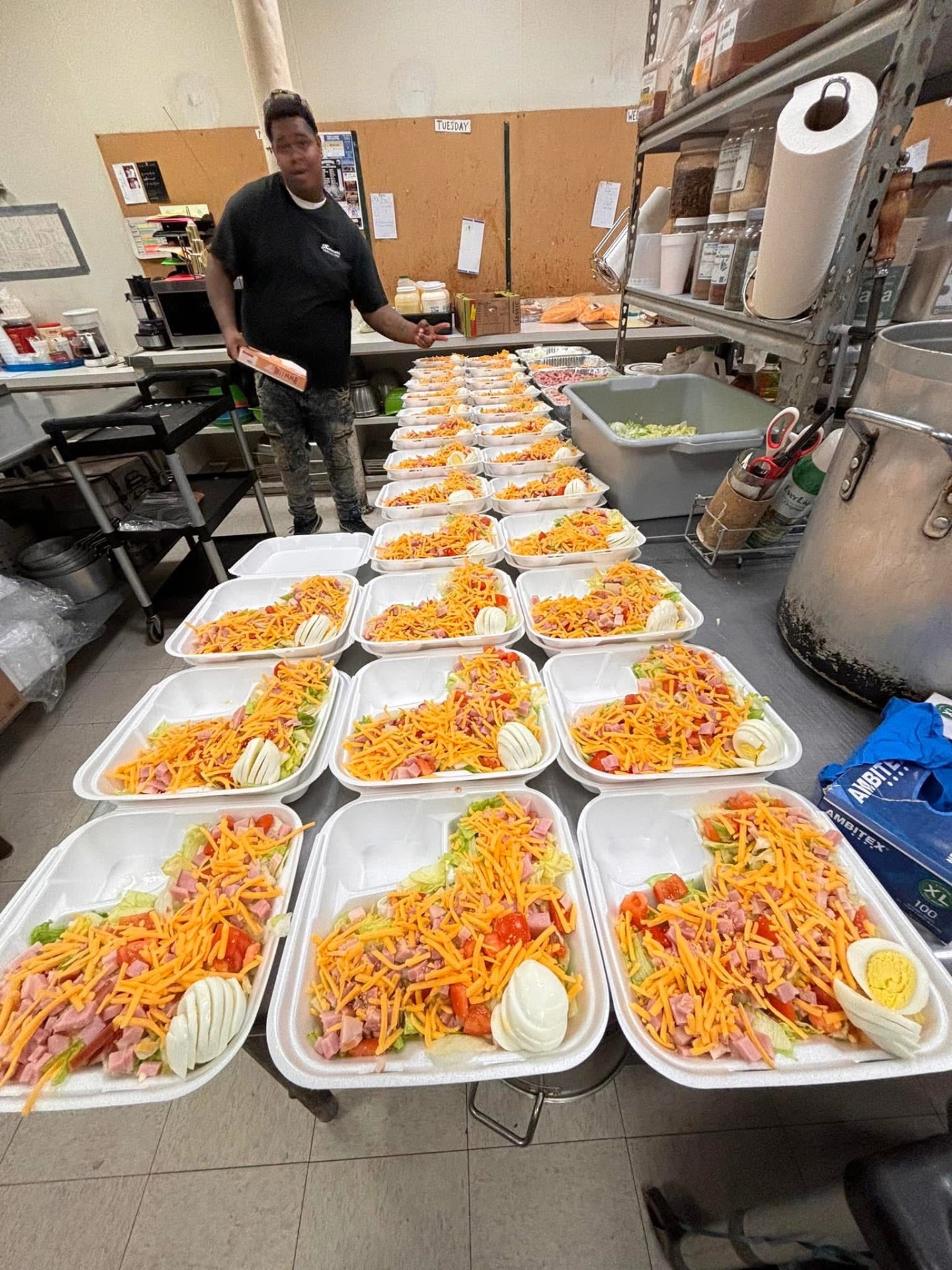 Kitchen assembly line of boxed chef salads
