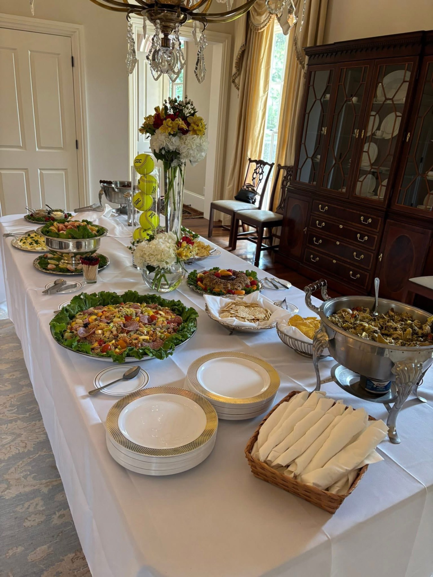 Buffet table featuring pasta salad and various dips